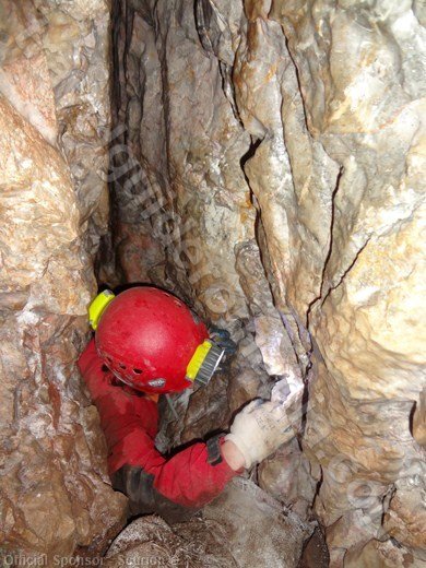 Exploring a narrow passage in a cave