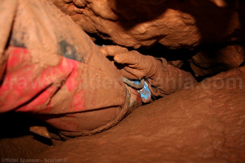 Passing a narrow passage in a cave