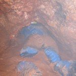 crawling through water in a cave