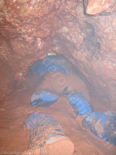 crawling through water in a cave